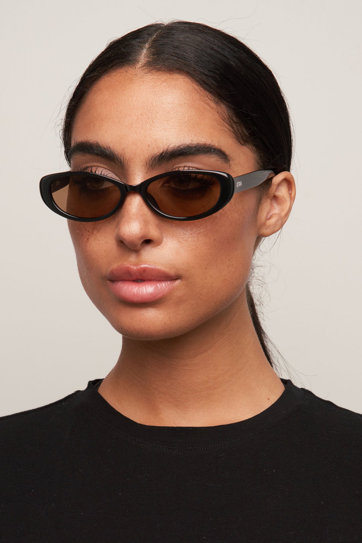 Model wearing Cami cat-eye sunglasses, side view