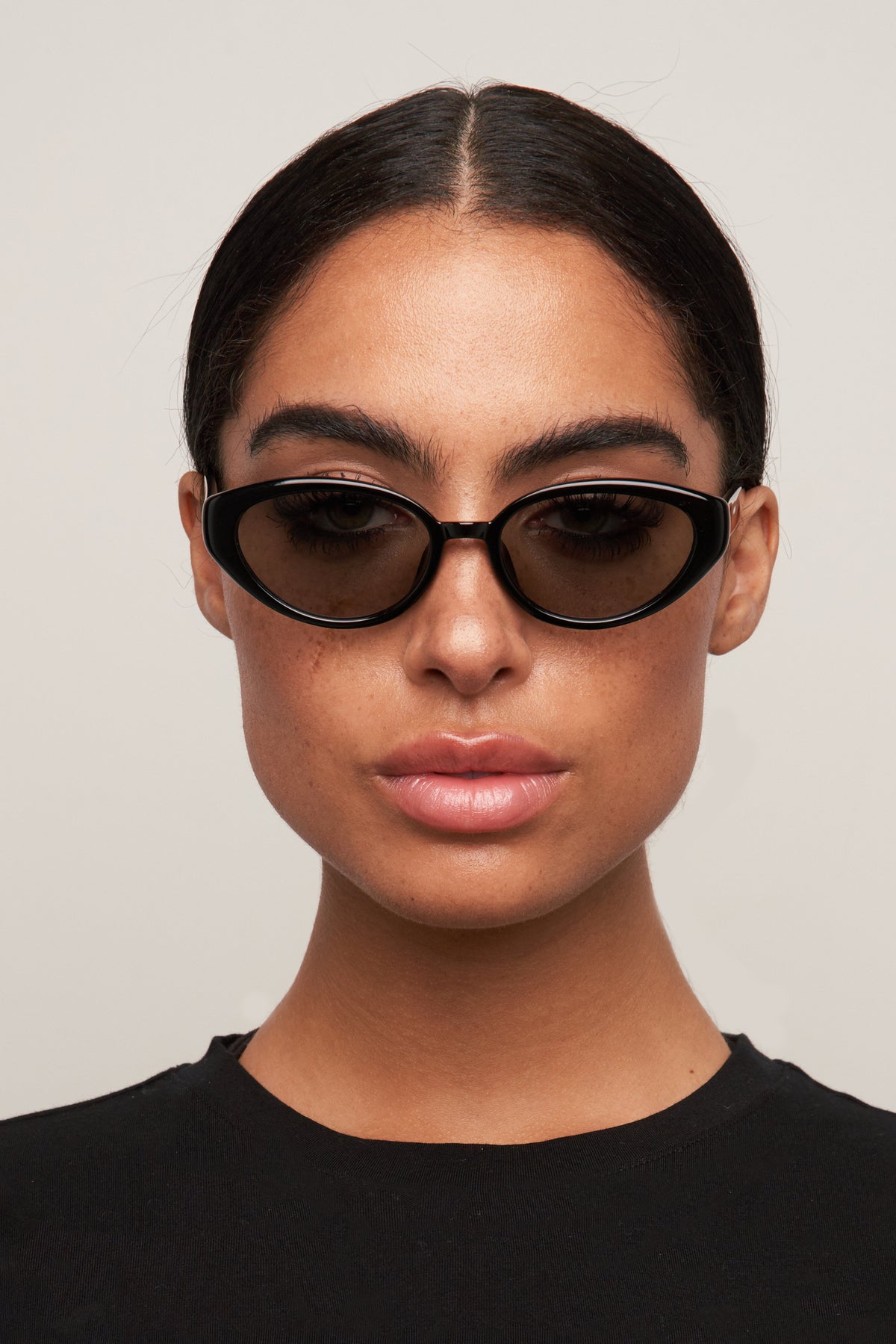 Model wearing Greta black cat-eye sunglasses