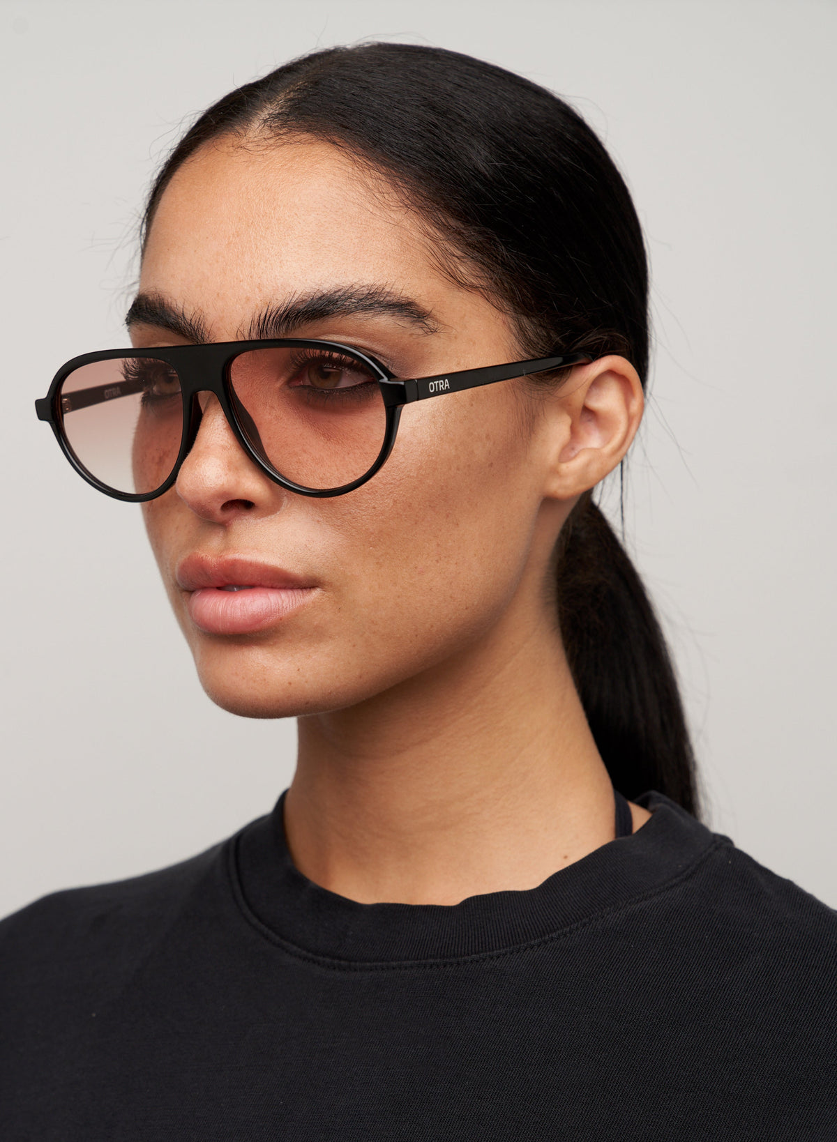 Model wearing Iggy black sunglasses, side view