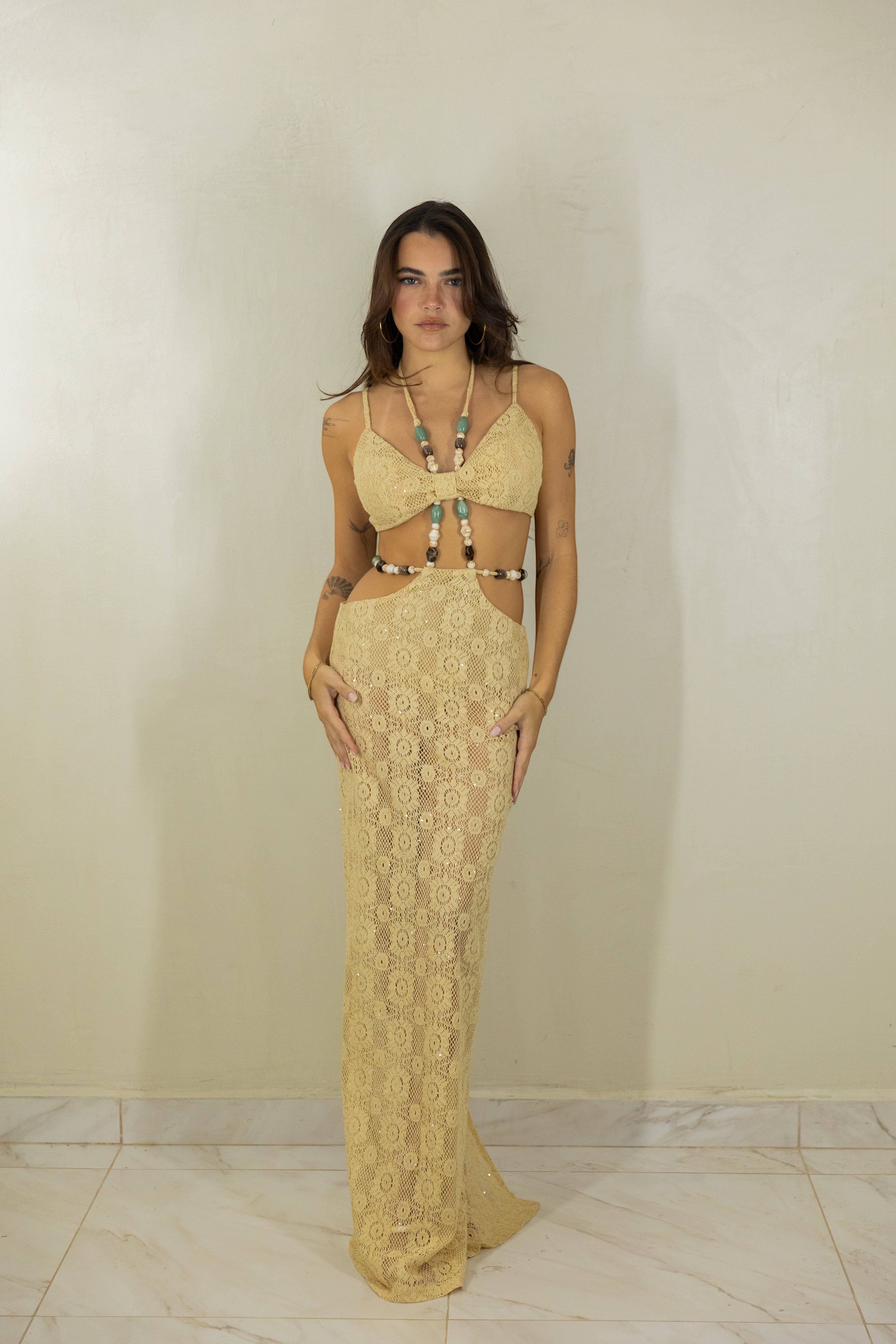 ISSUE 92 beige crochet maxi dress with cut-out waist and decorative wooden bead detailing worn by a model