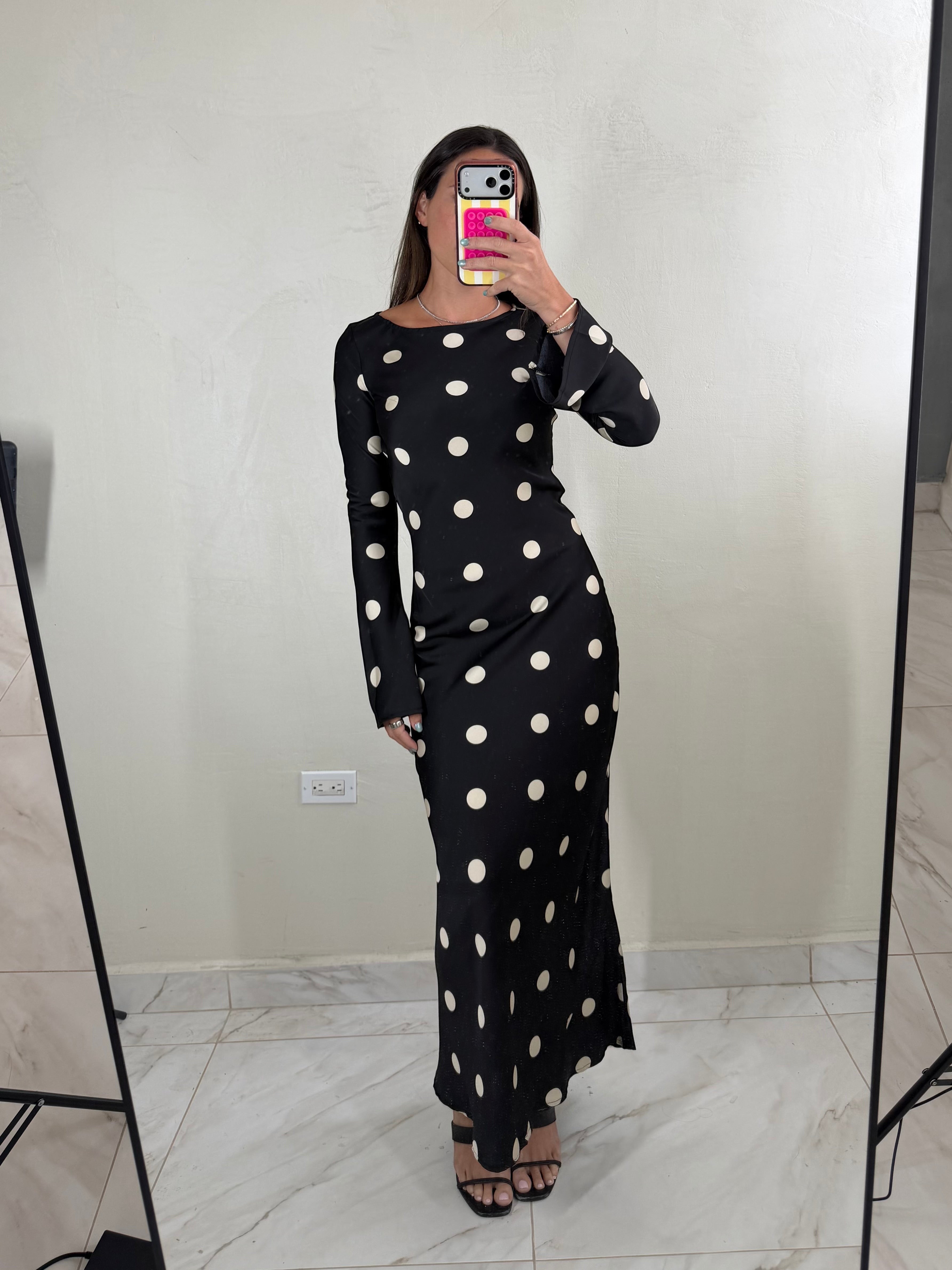 ISSUE 92 black maxi dress with white polka dots, long sleeves, and a slim fit worn by a model in a mirror selfie.