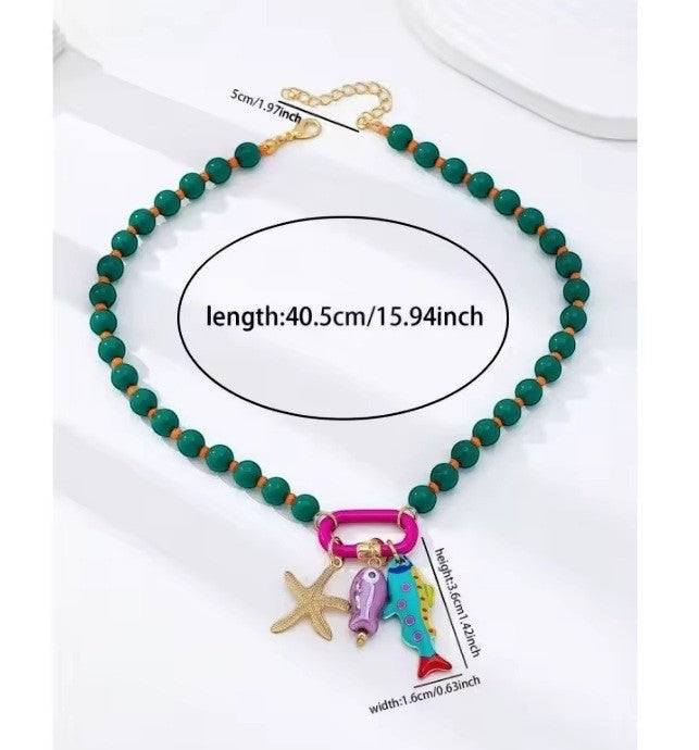 ISSUE 92 green beaded necklace with starfish and colorful fish charms. Gold chain extender.