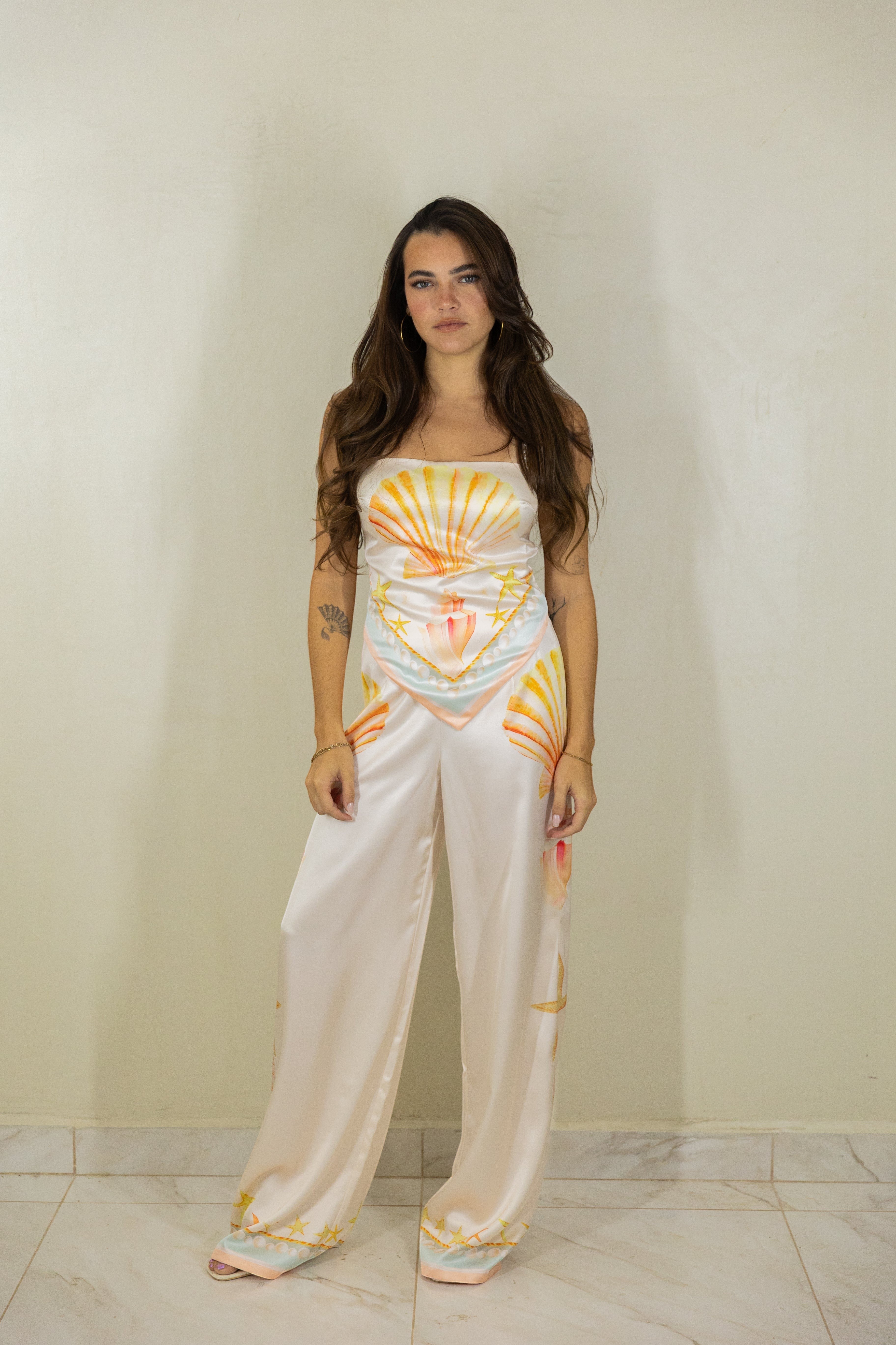ISSUE 92 Shell Set featuring a cream polyester camisole and wide-leg trousers with orange and yellow seashell print.