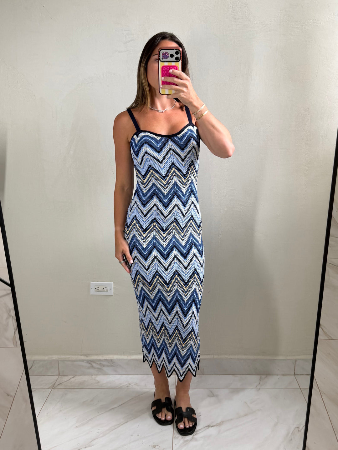 ISSUE 92 Ziggy Dress, a midi length knit dress with a blue, white, and yellow chevron pattern. Features spaghetti straps and a scalloped hem.