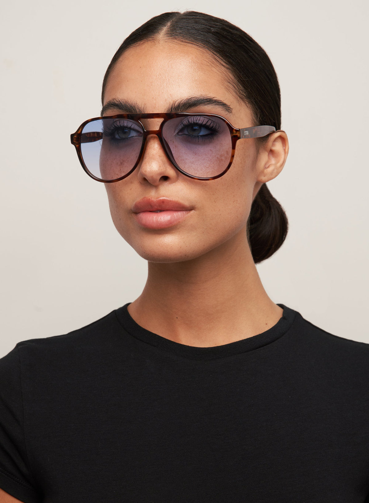 Model wearing Stevie tortoiseshell aviator sunglasses, side view